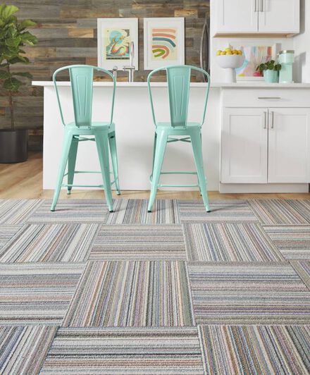  Kitchenette bar seating area with pastel blue chairs and FLOR area rug Thick And Thin shown in Wave